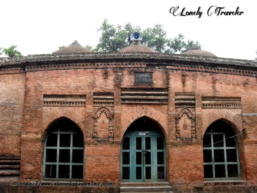 Baba Adam Mosque exterior view showing six domes and terracotta work